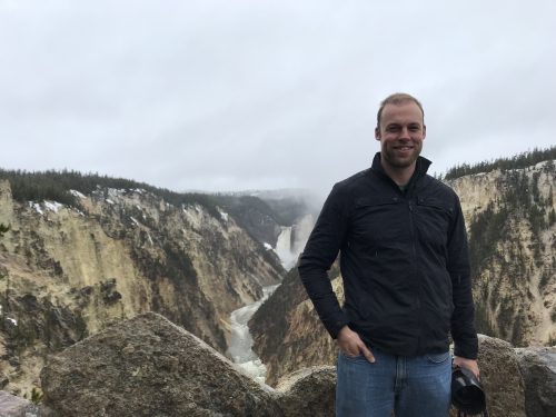 Me in front of the waterfall in Yellowstone National Park