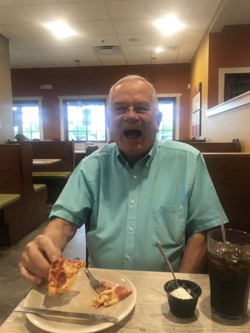 Grandpa eating spicy pizza