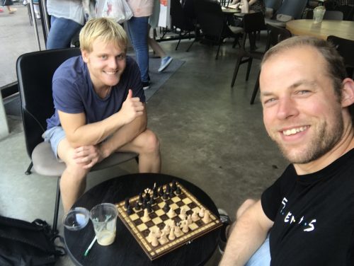 Playing chess with a friend in a coffee place