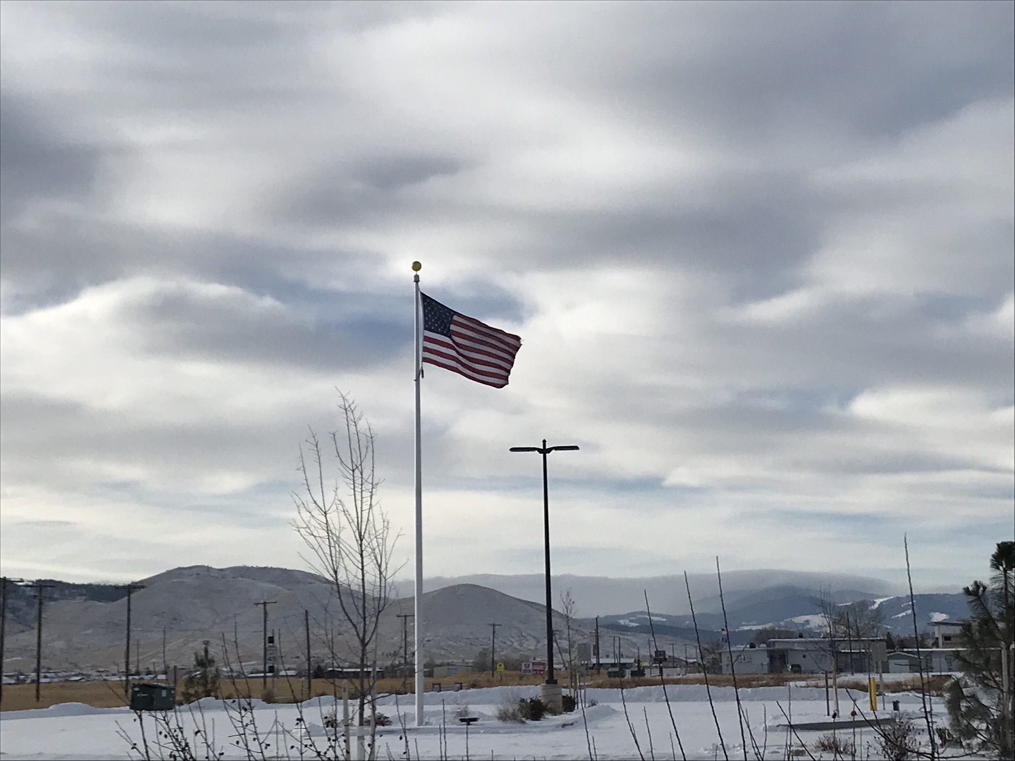 The American flag in front of the mountains